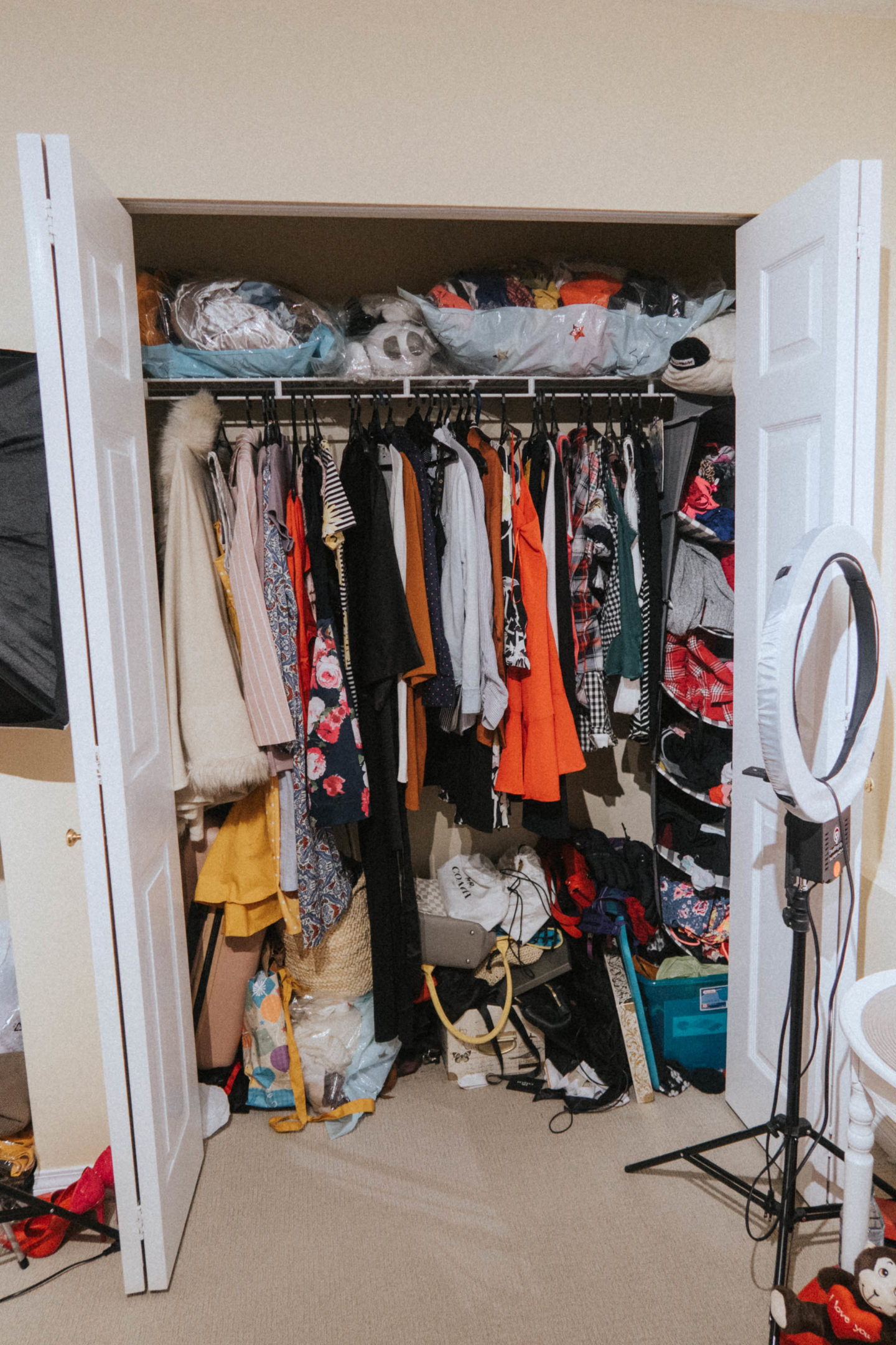 My overflowing closet before I started using the Konmari Method to organize and spark joy