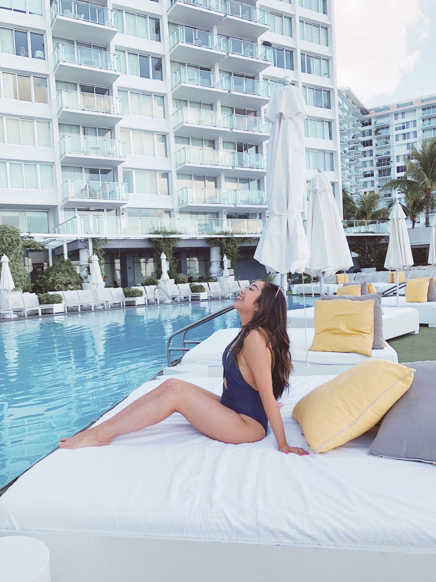 Relaxing poolside in Miami with my blue one-piece swimsuit from Adore Me 