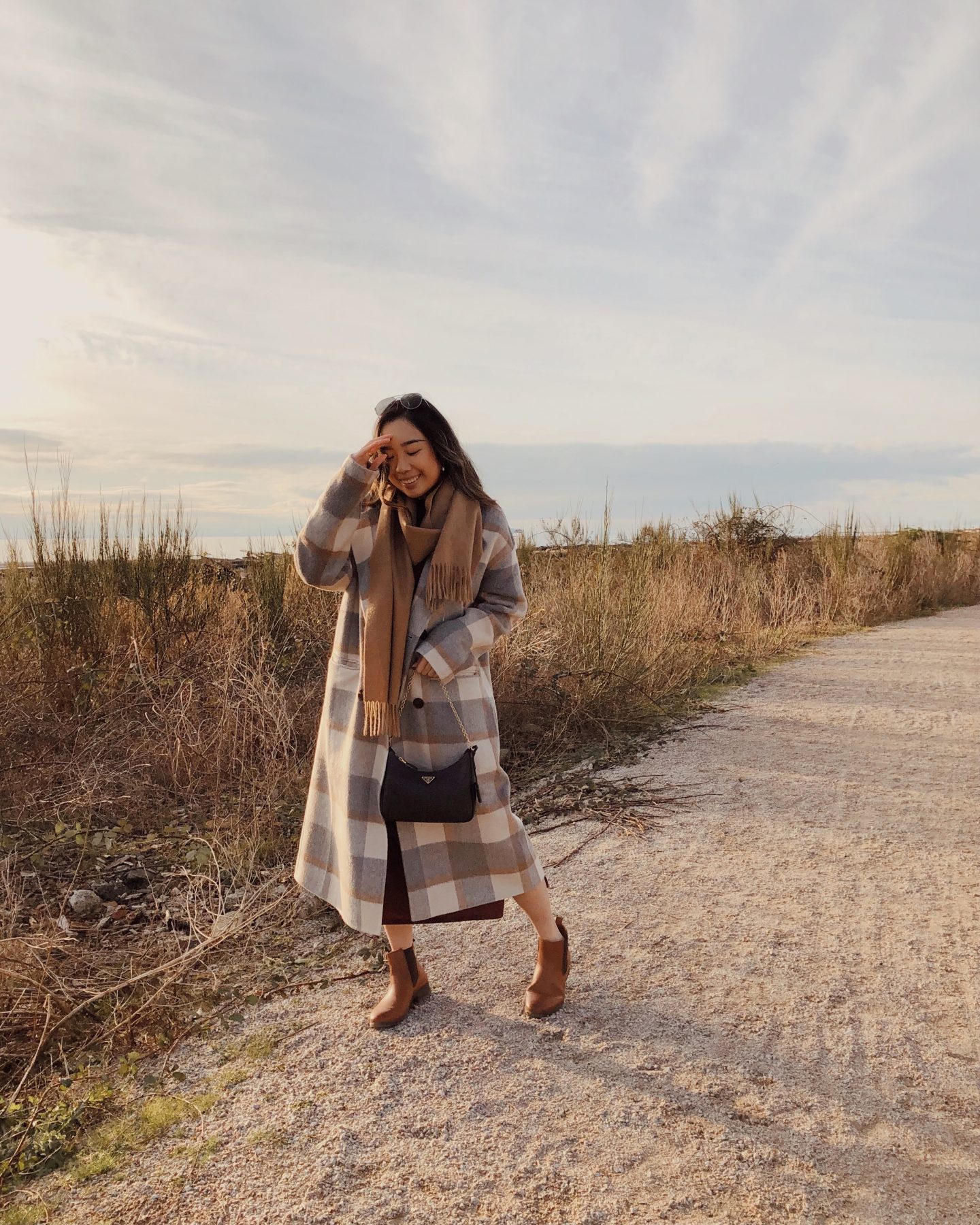 Taking a stroll on the beach with my plaid wool coat and brown boots