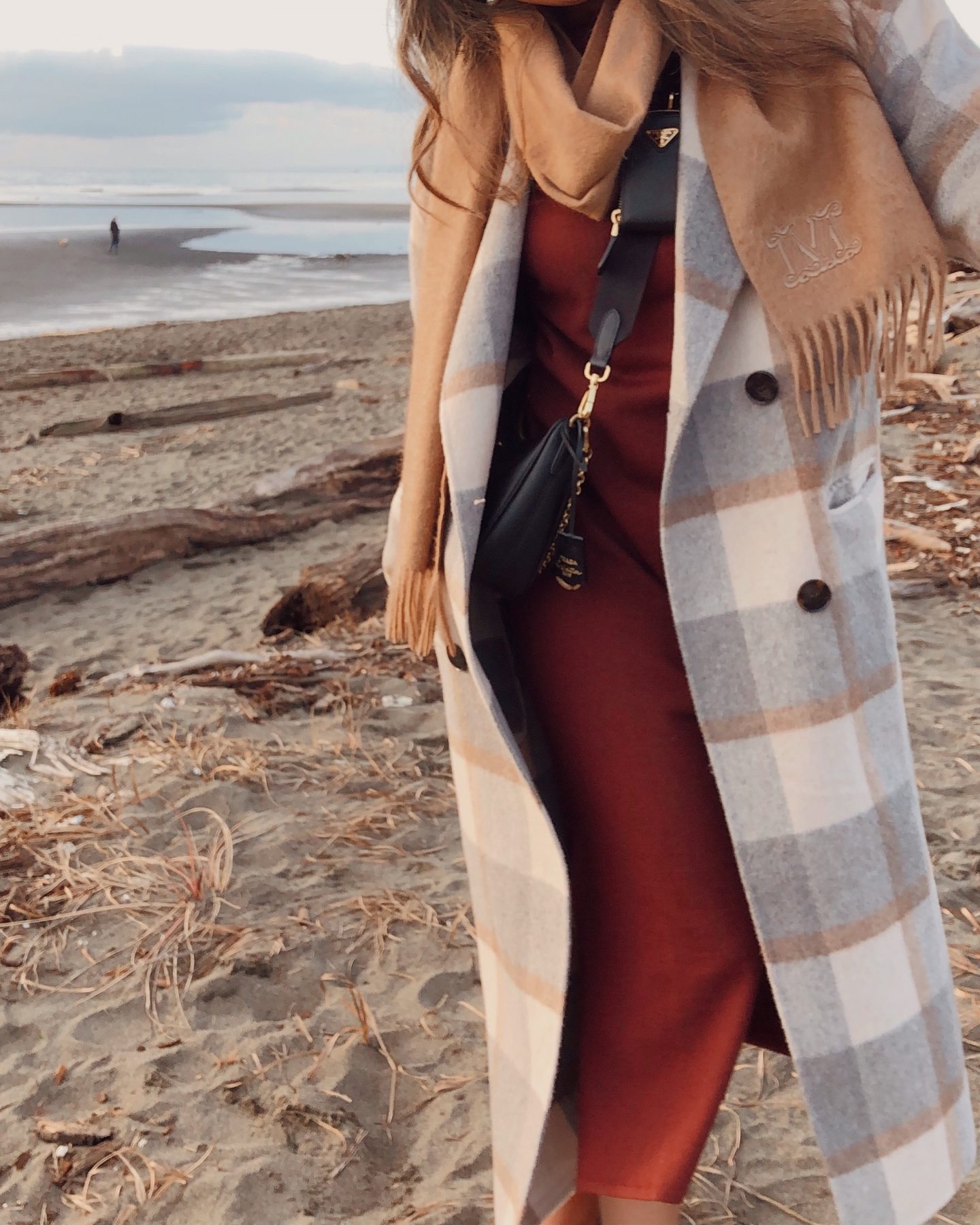 trying out a different photo angle on the beach with my plaid coat and scarf on a winter day