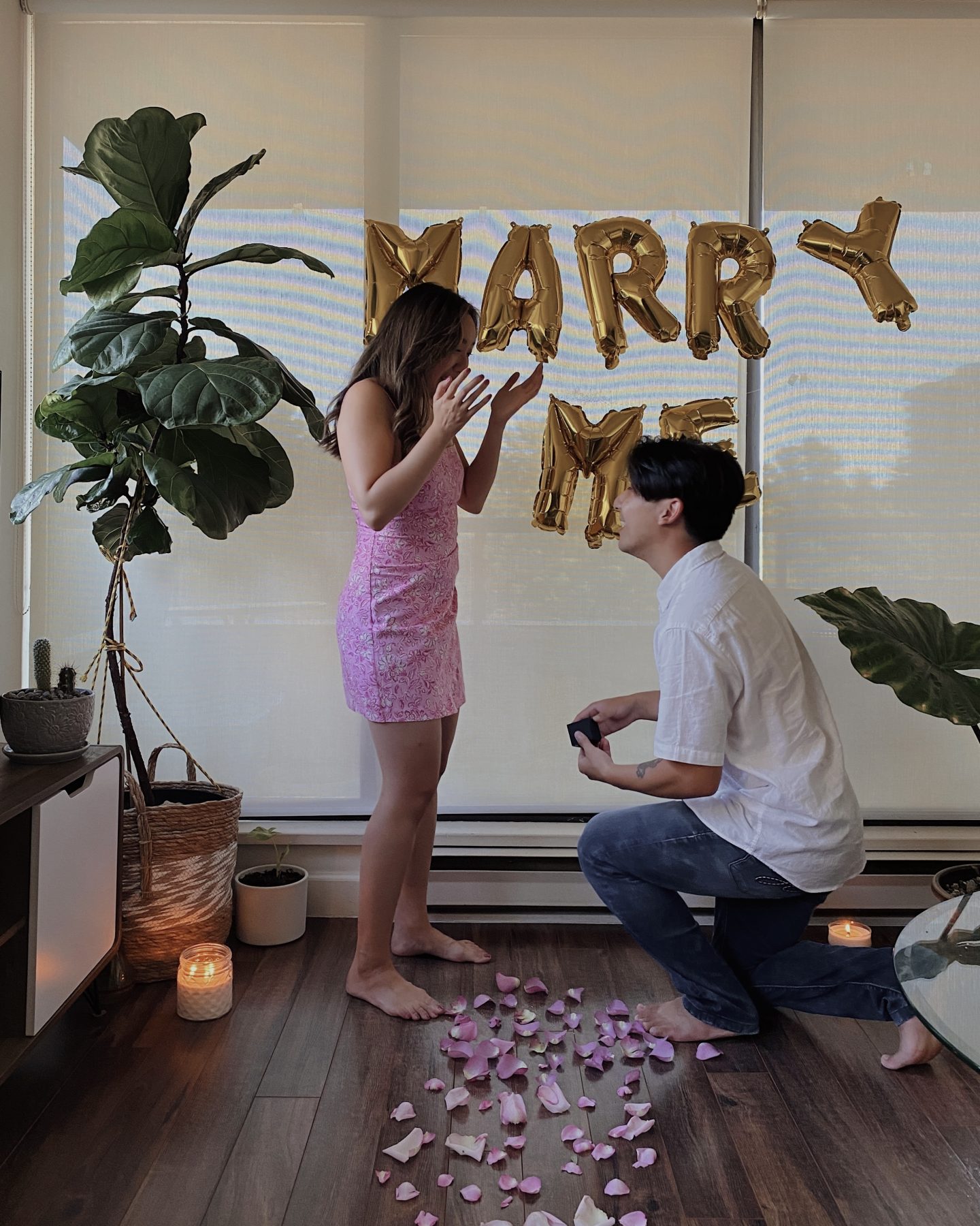 Girl getting proposed to in front of a will you marry me sign