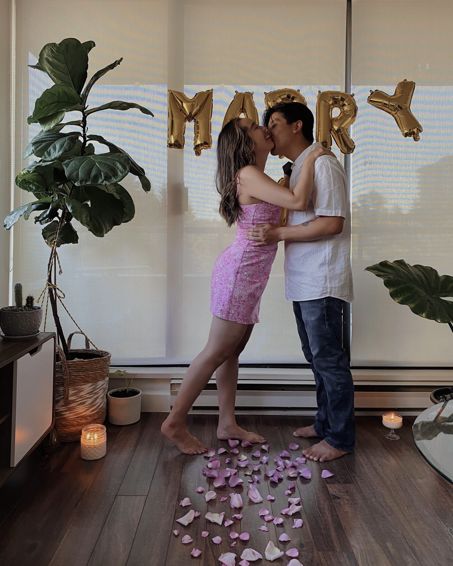 A proposal in front of a will you marry me sign