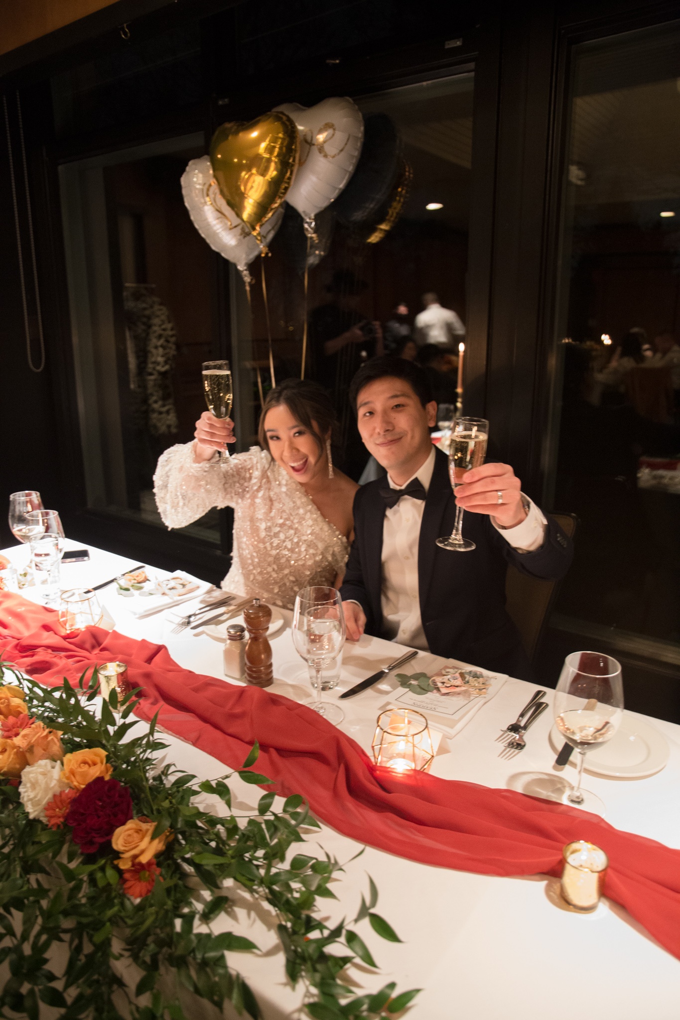 My husband and I sitting at a table celebrating after planning my engagement party