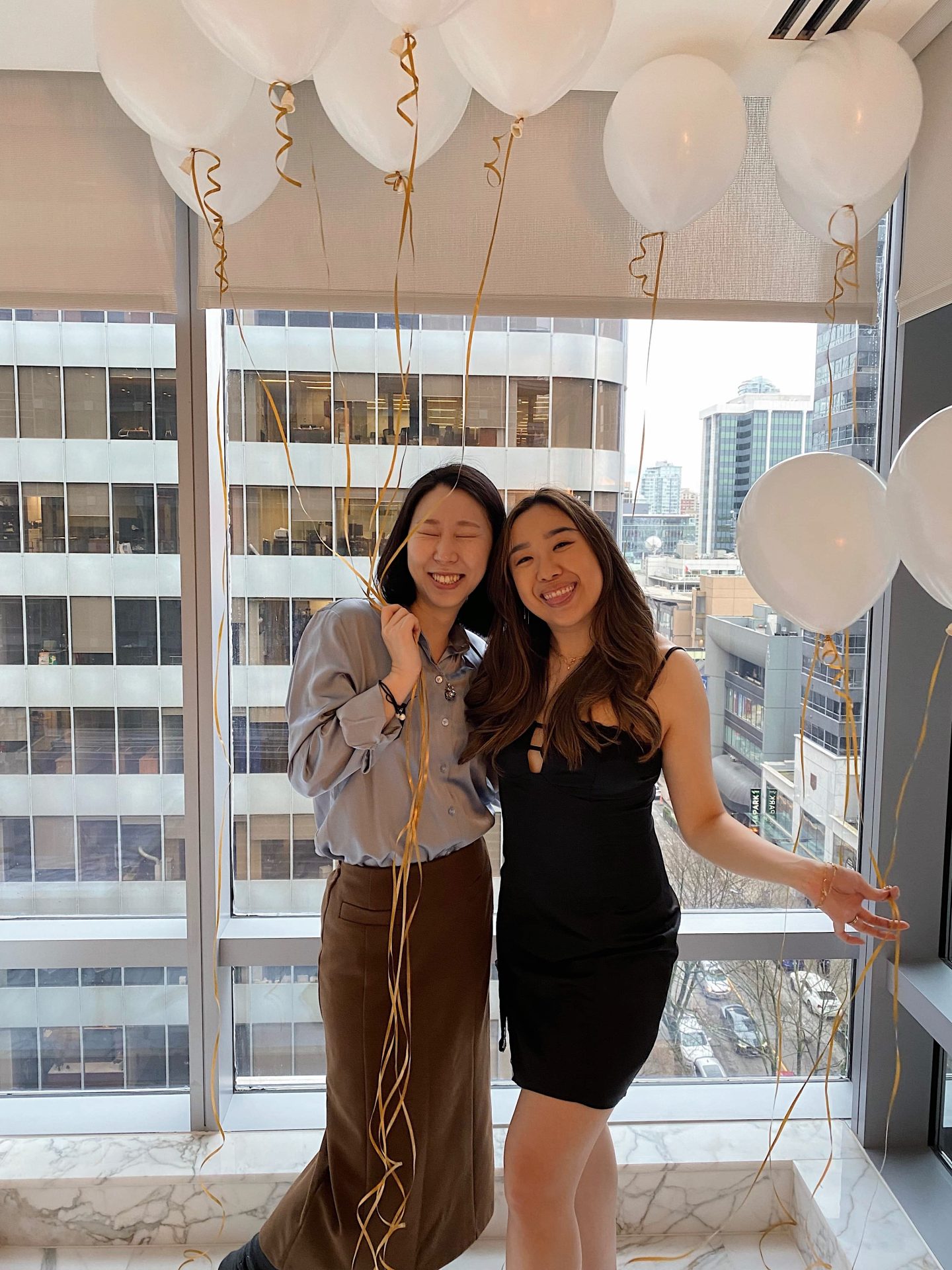 Giving my bridesmaid a hug during my bridesmaid proposal posing with our balloons