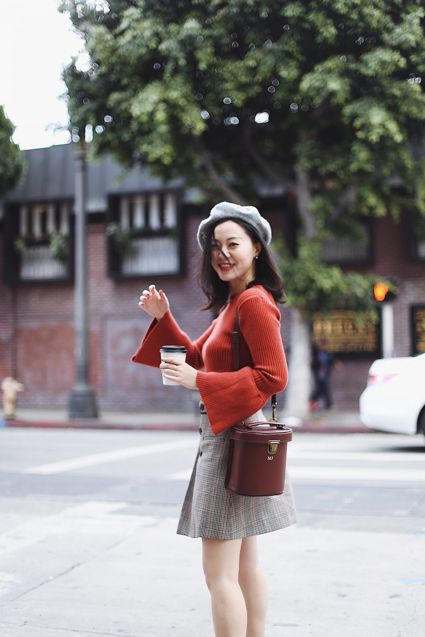 1 piece 2 ways - pairing checkered skirt with beret brown bag and bell sleeved red top 