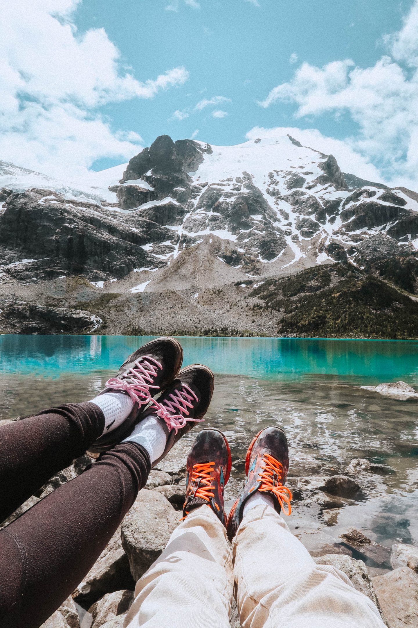 Showing our hiking shoes near Joffre Lakes and mountains 