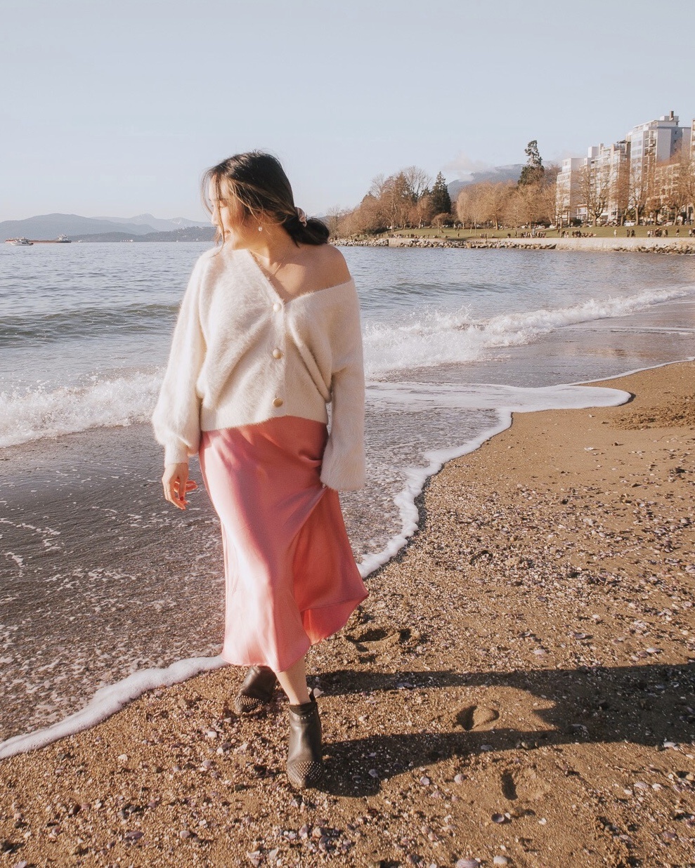 Walking along the beach in a flowy pink skirt