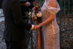 Man on the left wearing a tux women on the right wearing a wedding dress